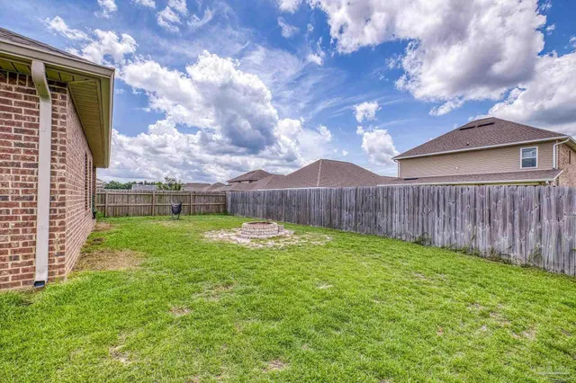 a view of an house with backyard space and garden view