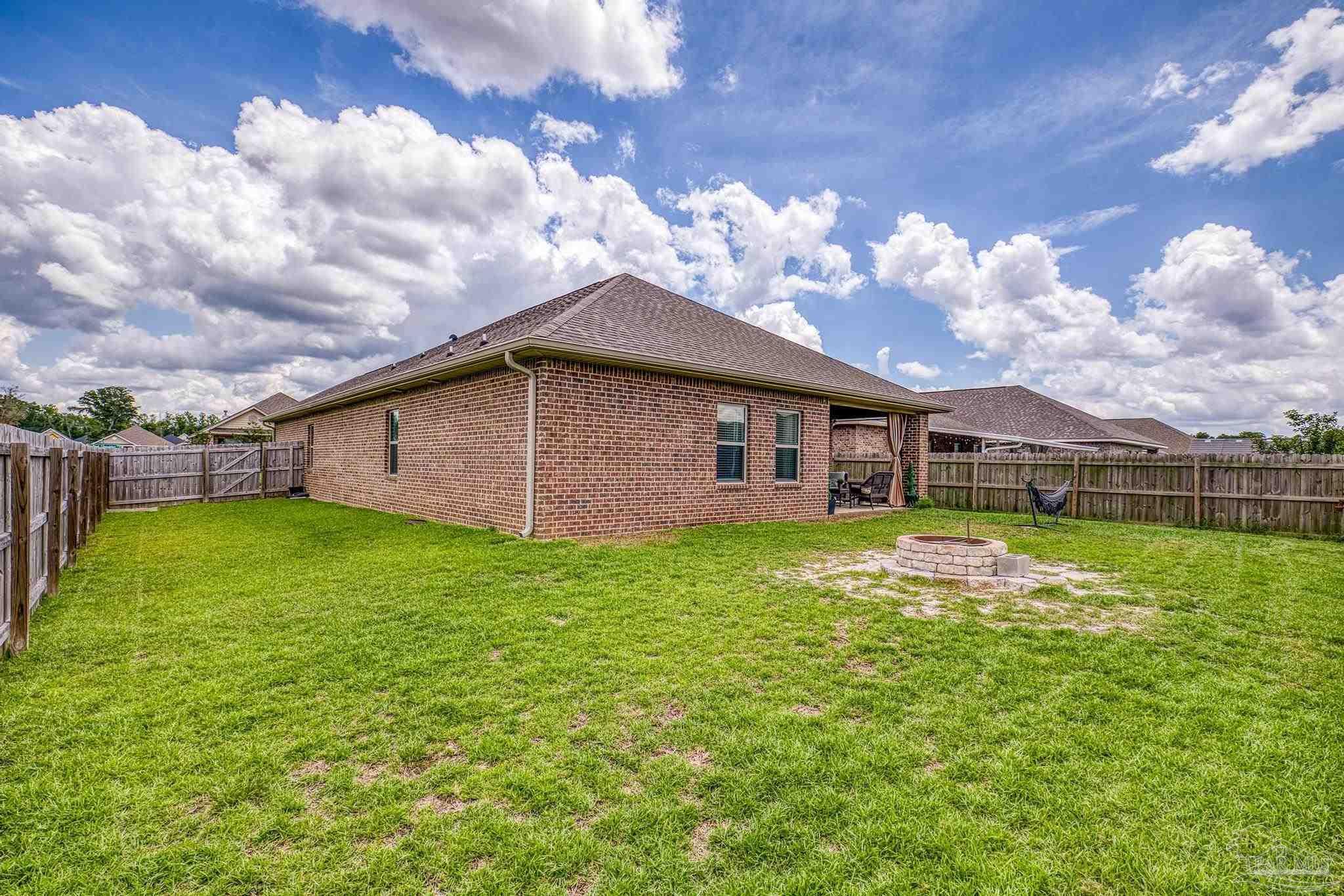 5375 Red Shoulder Road Pace, FL 32571 - Photo 33 of 40 a backyard of a house with lots of green space