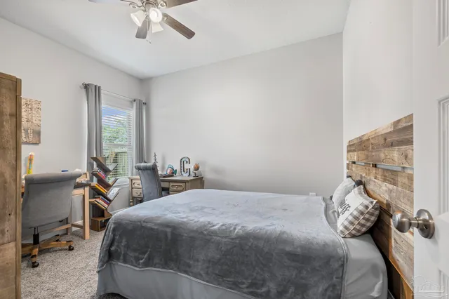 a bedroom with a bed and a television