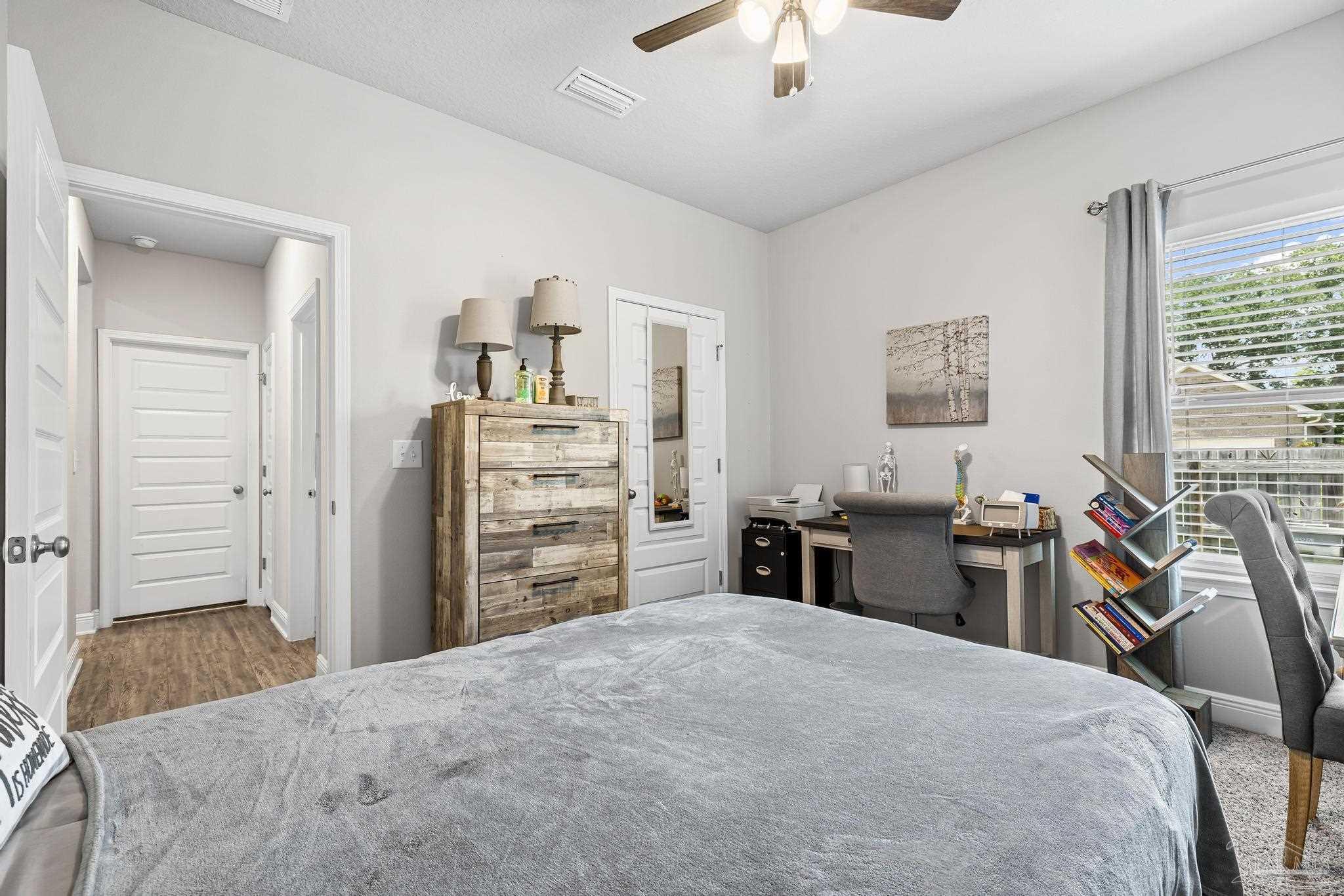 5375 Red Shoulder Road Pace, FL 32571 - Photo 7 of 40 a bedroom with a bed and furniture