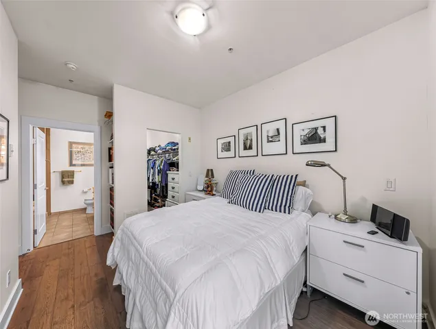 a bedroom with a large bed and a chandelier