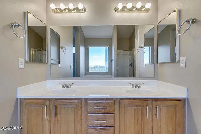 a spacious bathroom with a granite countertop sink and a mirror