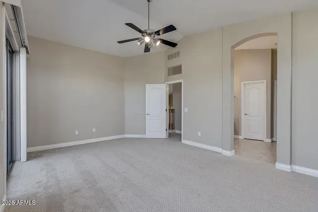 an empty room with windows and closet
