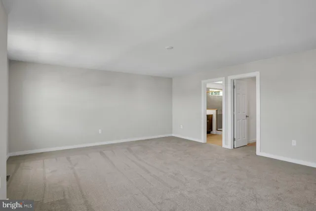a view of an empty room and closet area