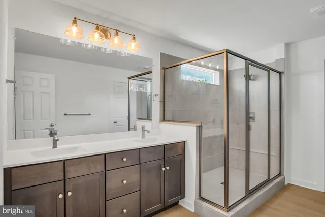 a bathroom with a double vanity sink and mirror