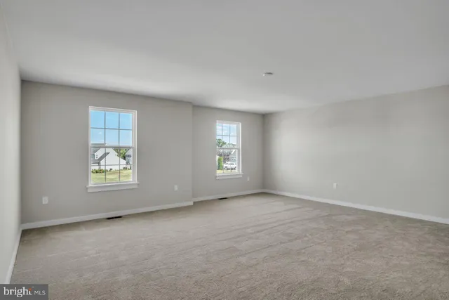 an empty room with windows and mirror