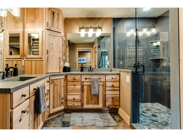a bathroom with a sink a vanity and a large mirror