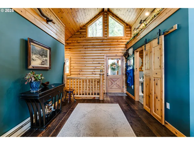 a kitchen with stainless steel appliances kitchen island granite countertop a table chairs and a wooden floor