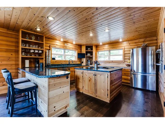 a dining room with wooden floor a chandelier a wooden table and chairs