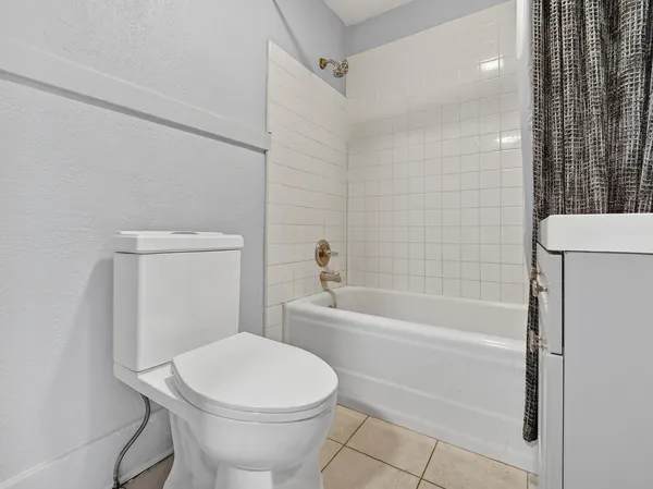 a bathroom with a toilet and a bath tub