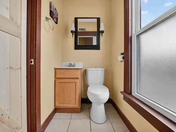 a bathroom with a sink toilet and mirror