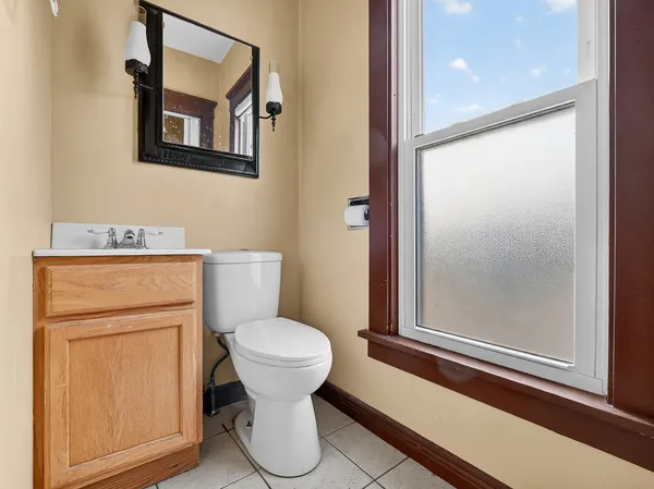 a bathroom with a toilet sink and mirror