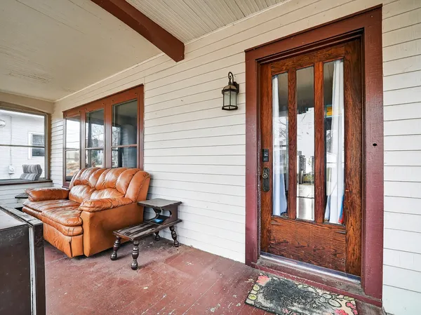 a living room with furniture a window and a glass door