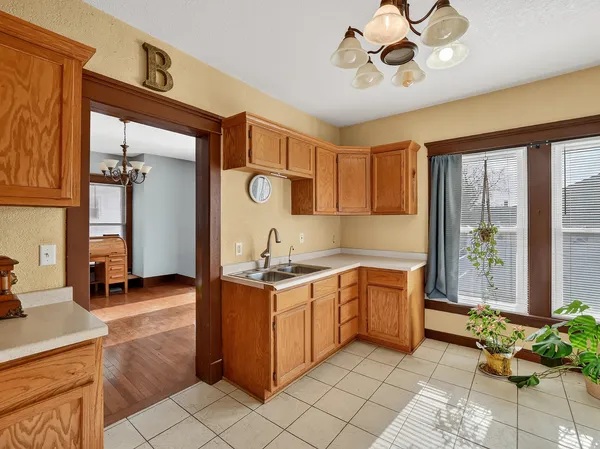 a kitchen with a stove a sink and cabinets