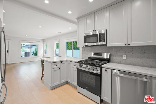 a bathroom with a bathtub shower sink mirror and toilet