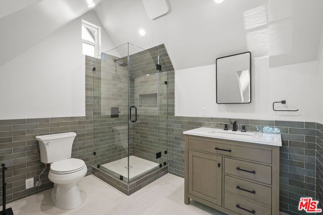 a living room with furniture a rug and a bookshelf