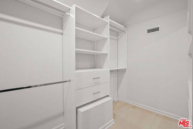 a bedroom with furniture and a flat screen tv