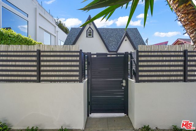 a view of a patio with couches table and chairs and potted plants