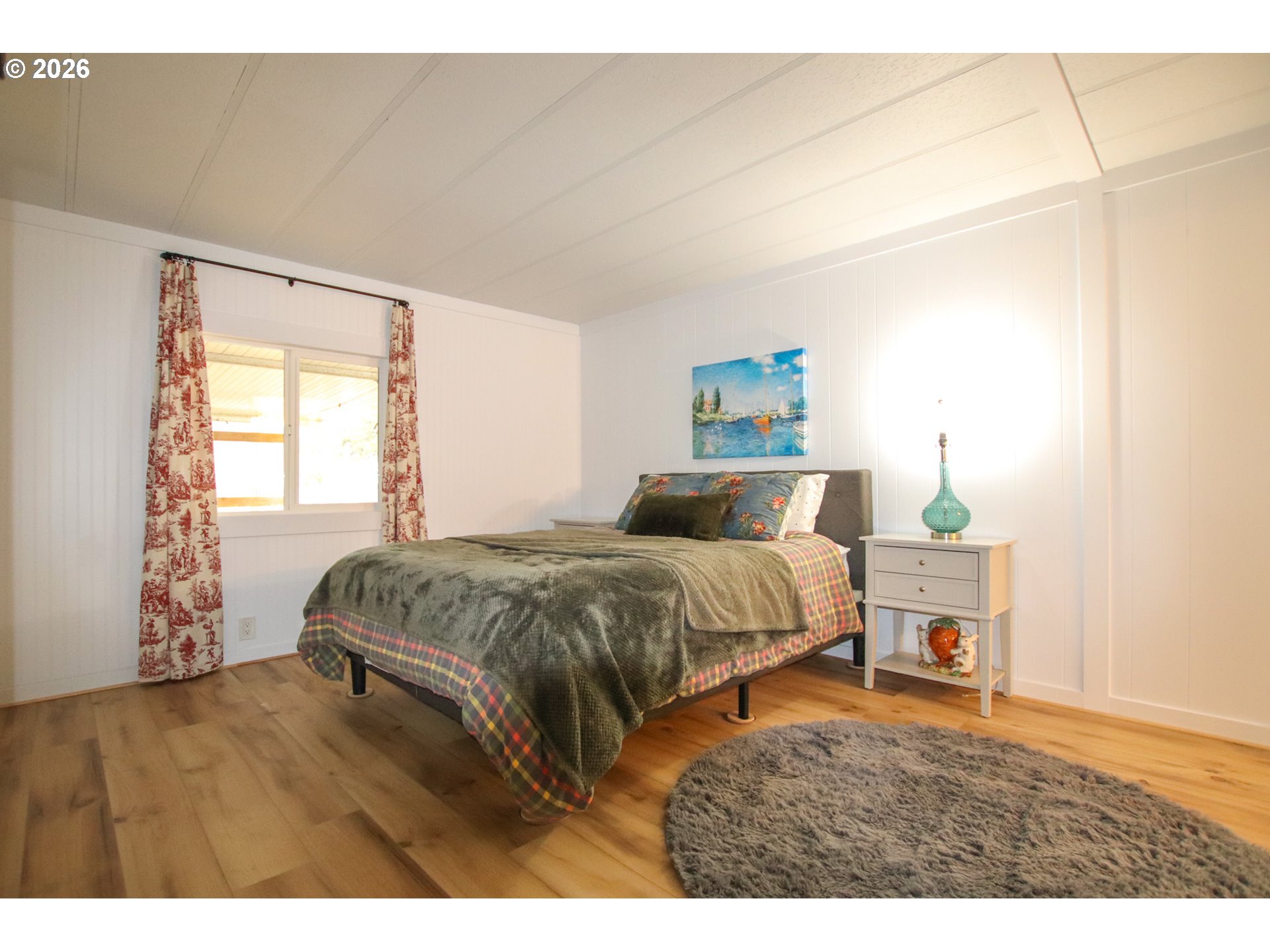 1431 Maple Street Florence, OR 97439 - Photo 26 of 43 a bedroom with a bed and a window