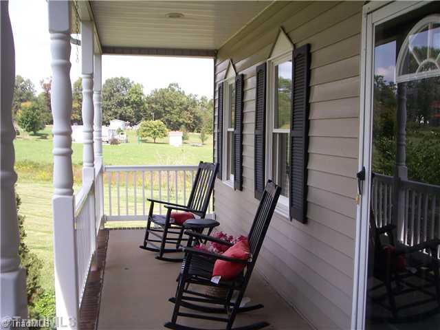 262 Eldora Road Ararat, NC 27007 - Photo 4 of 16 Exterior Front. Rocking Chair front porch with vinyl railing, No painting this porch.