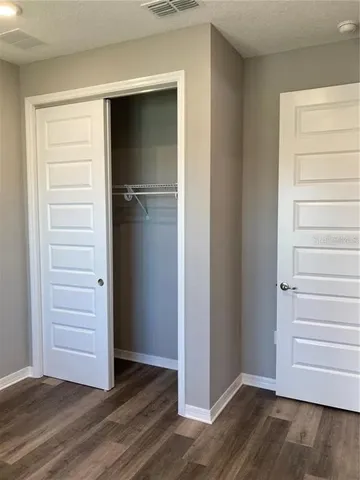 a view of walk in closet with empty racks