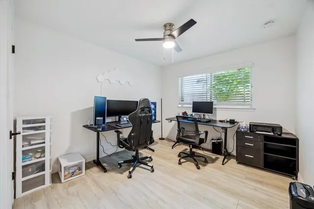 a view of a workspace with furniture and a window