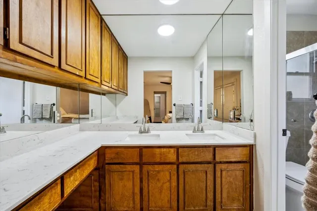 a bathroom with a granite countertop sink and a mirror