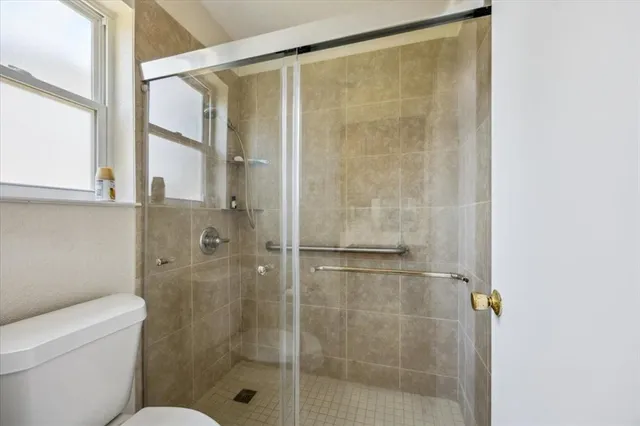 a bathroom with a shower and toilet