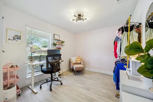 a view of a workspace with furniture and a window