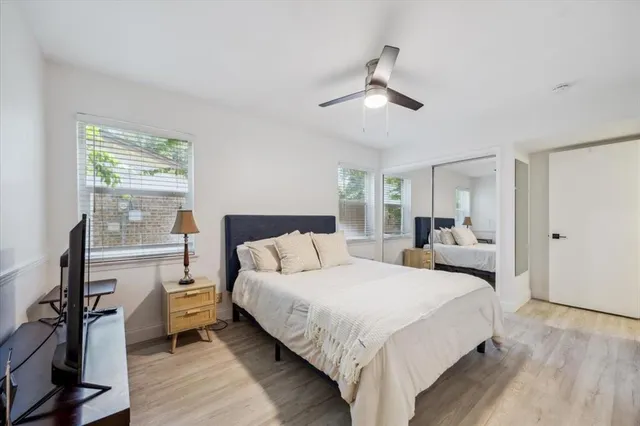 a bedroom with a bed and a large mirror