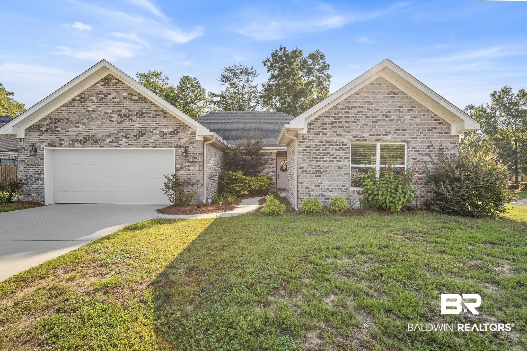 113 Timberline Drive Daphne, AL 36526 - Photo 1 of 44 Ranch-style home with a front lawn, brick siding, concrete driveway, a garage, and roof with shingles