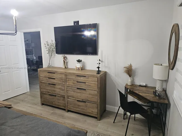 a room with furniture and a flat screen tv