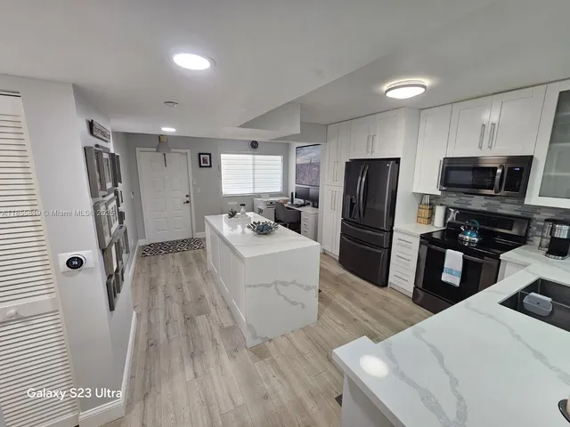 a living room with furniture a rug and a chandelier