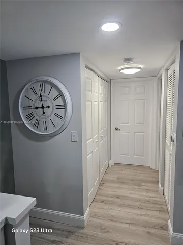 a kitchen with a refrigerator sink and cabinets