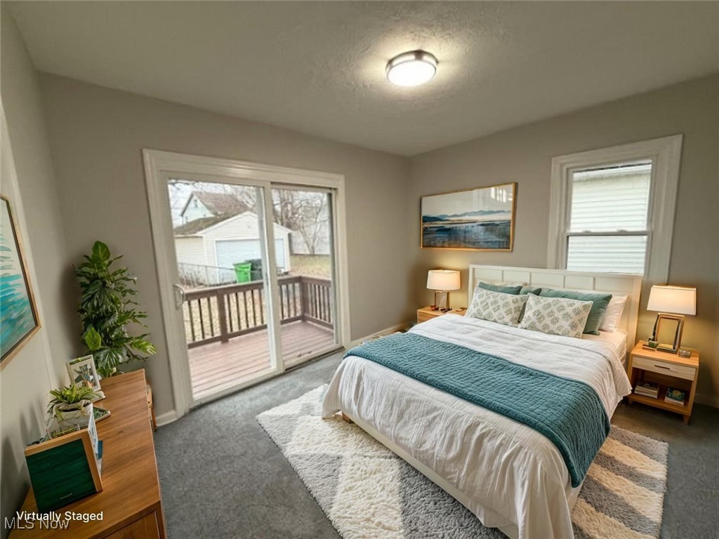 4658 Burleigh Road Cleveland, OH 44125 - Photo 15 of 24 Carpeted bedroom with multiple windows, access to exterior, and a textured ceiling