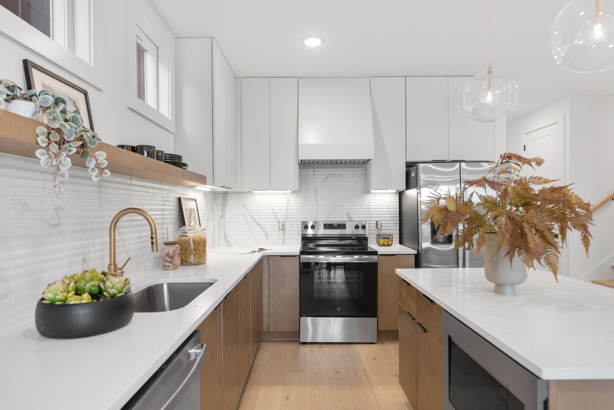 3025 Edwin Street Nashville, TN 37207 - Photo 13 of 48 a kitchen with stainless steel appliances granite countertop a sink dishwasher and cabinets with wooden floor