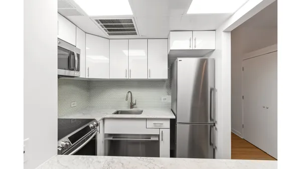 a kitchen with stainless steel appliances granite countertop a sink a stove and cabinets