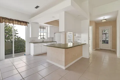 an empty room with chandelier fan