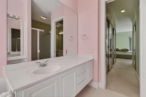 a front view of a house with plants and trees