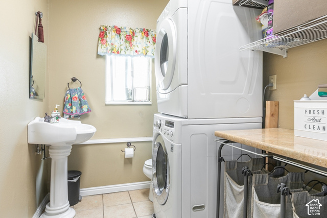 1764 West 1200th Street North Mapleton, UT 84664 - Photo 32 of 35 Pedestal sink, stacked laundry appliances, tiled flooring, built-in shelving, and countertop space