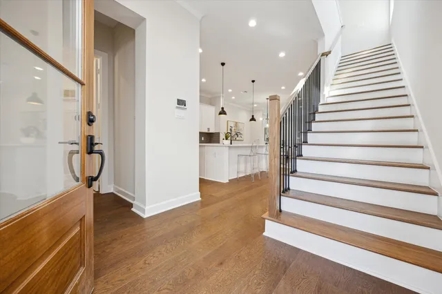 a view of entryway with wooden floor and stairs