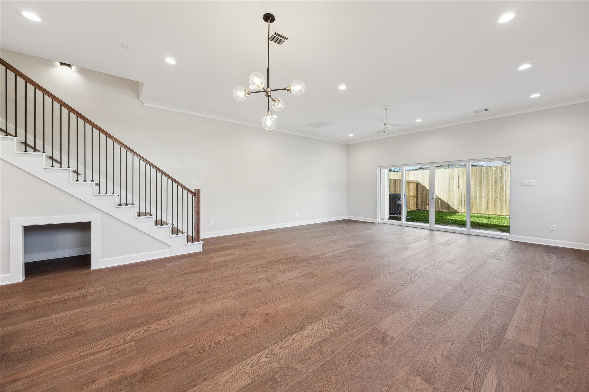 1303 Cordell Street, Unit B Houston, TX 77009 - Photo 14 of 41 a view of an empty room with wooden floor floors and a window
