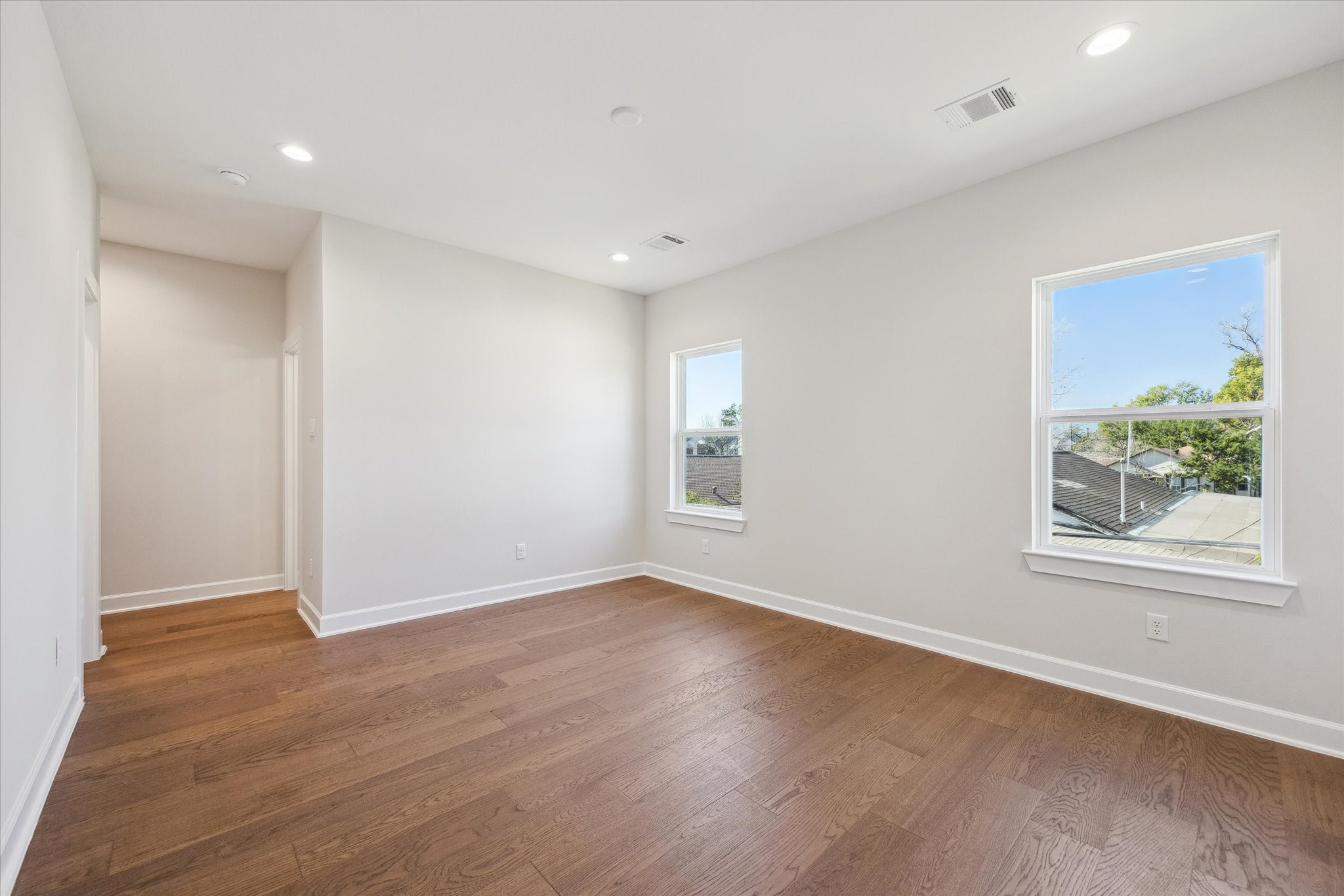 1303 Cordell Street, Unit B Houston, TX 77009 - Photo 33 of 41 an empty room with wooden floor and windows