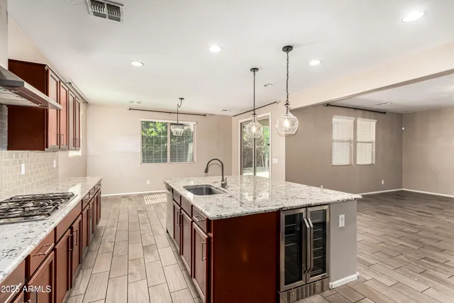 a kitchen with sink stove and cabinets