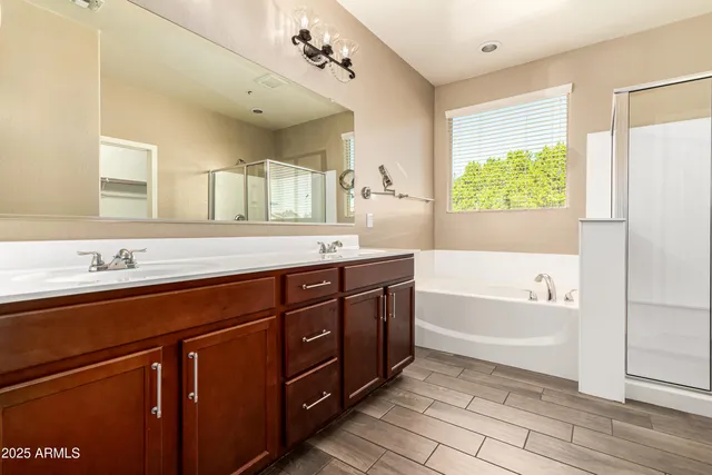a spacious bathroom with a tub sink and mirror