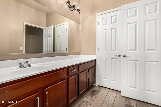 a bathroom with a double vanity sink and a mirror