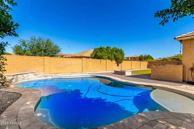 a view of a swimming pool with a table and chairs