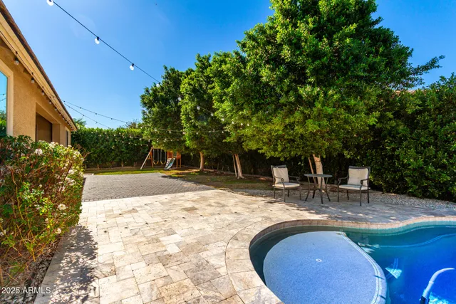 a swimming pool with outdoor seating and yard