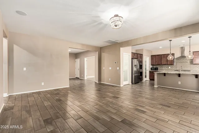 a view of a kitchen with wooden floor and a kitchen