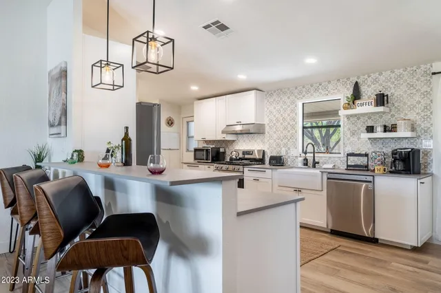 a kitchen with a sink stove and cabinets